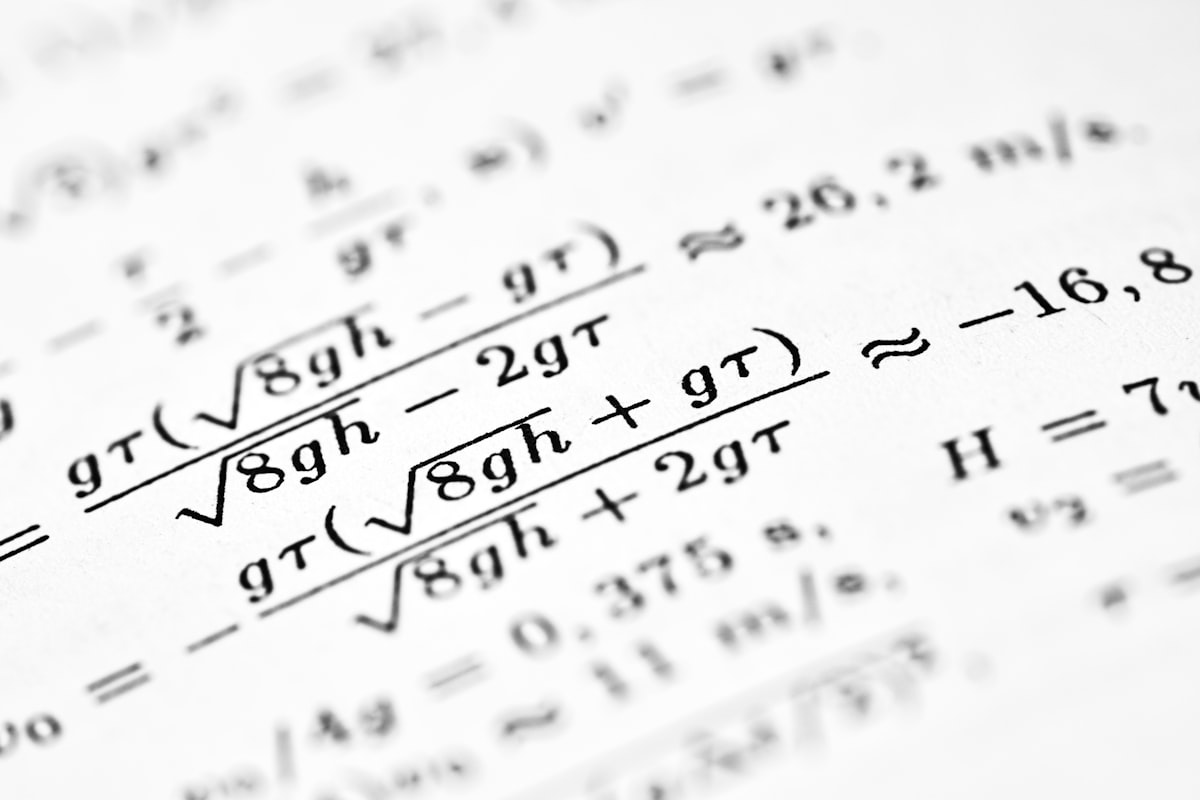 Mathematical formulas are shown on the paper.