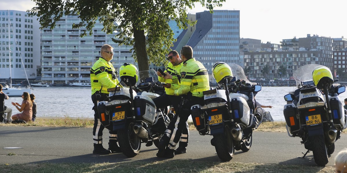 Police officers with motorcycles by the water