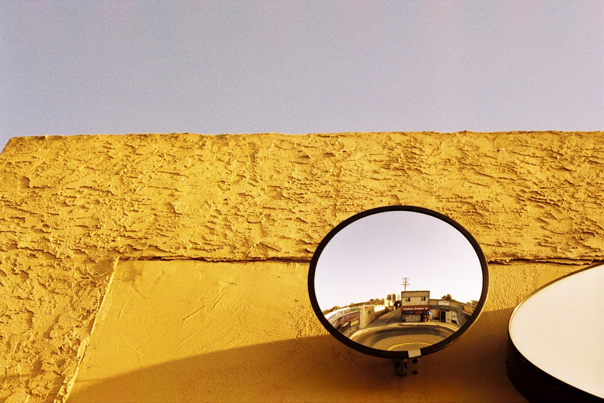 black round mirror on brown wall
