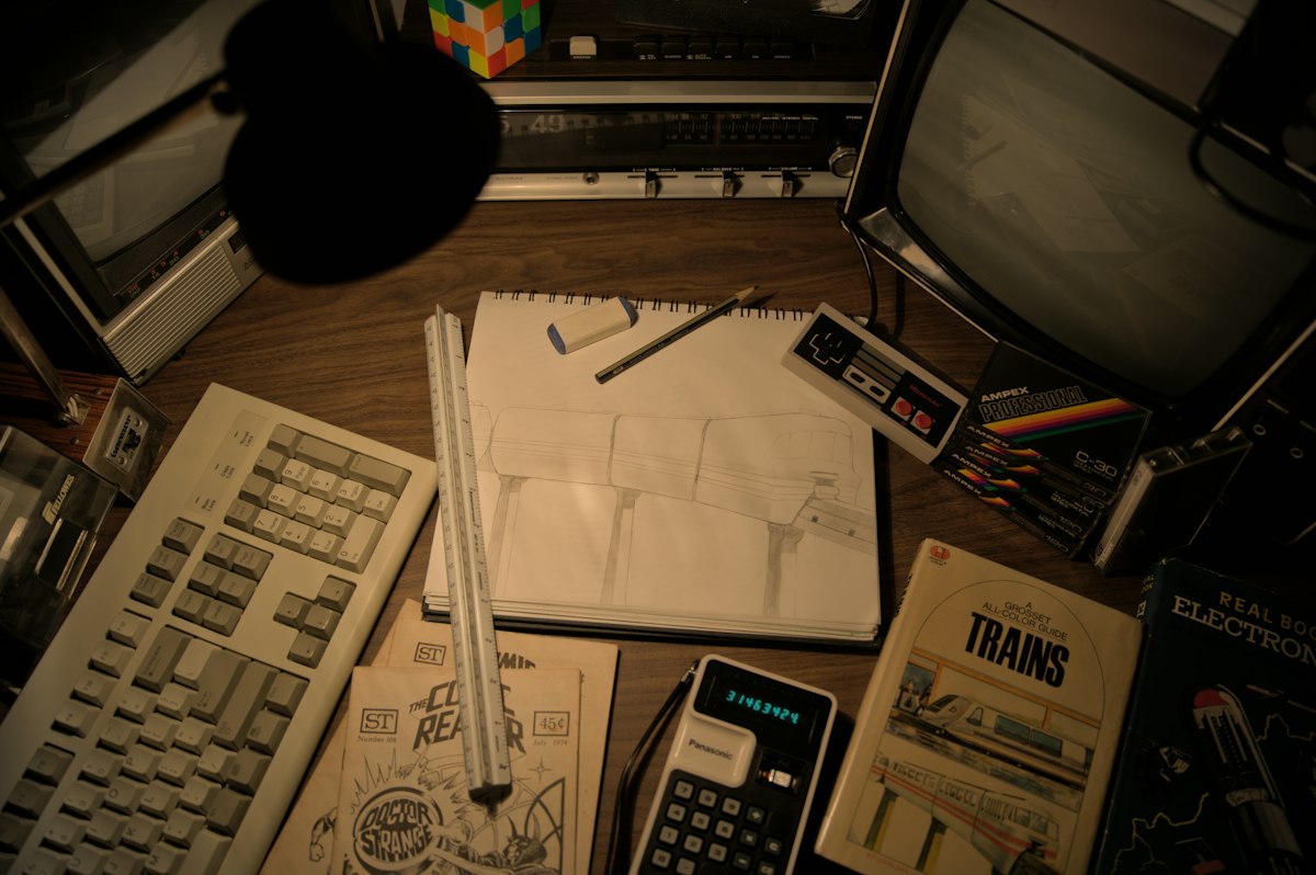 Retro desk with vintage computer and drawing supplies