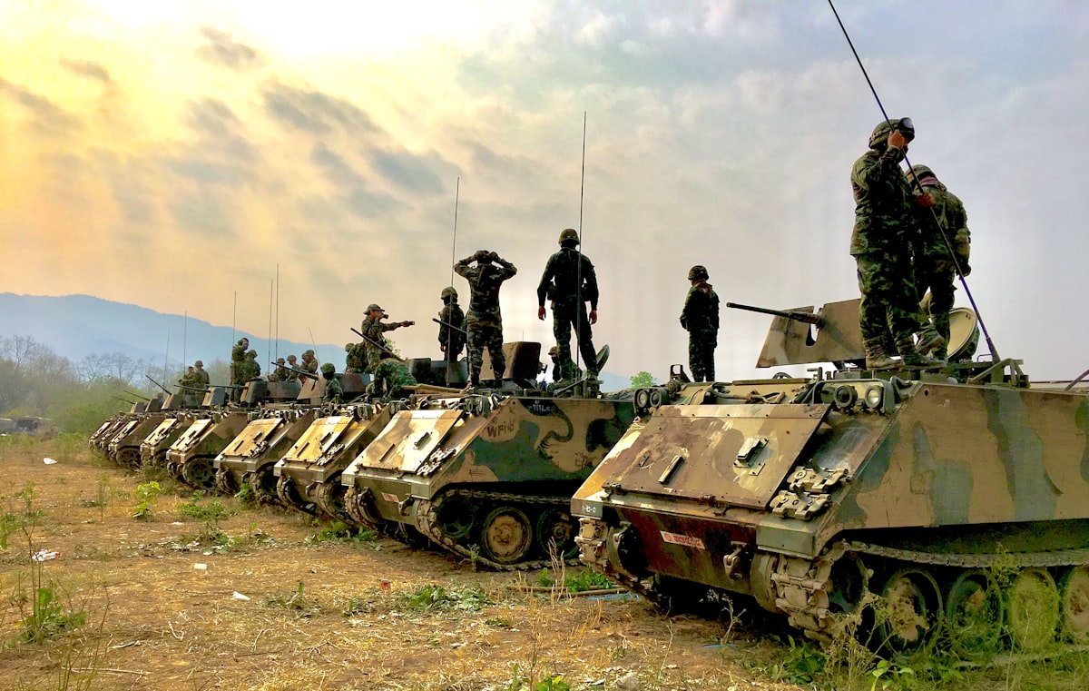 soldiers on top of battle tanks