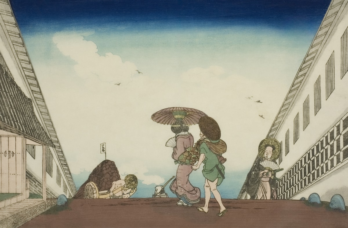 Two people walk under an umbrella on a street.