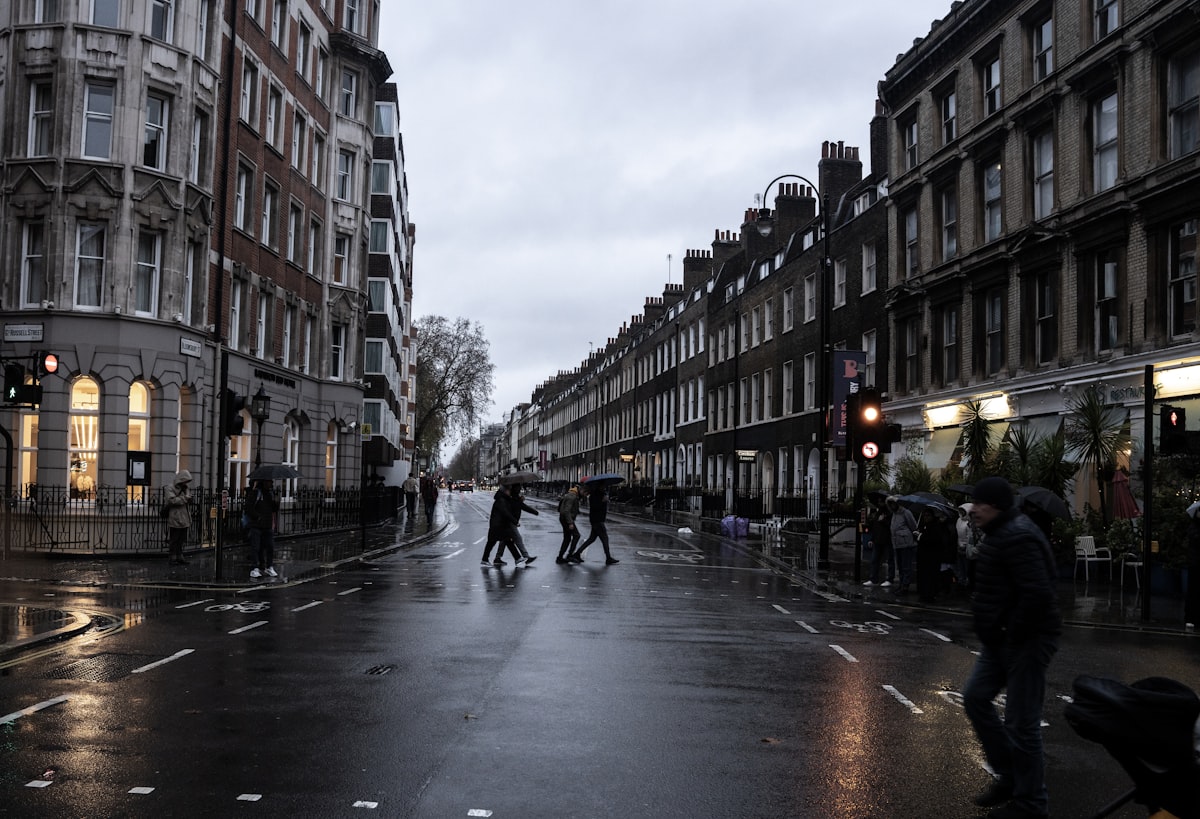 Rainy street scene with people crossing road