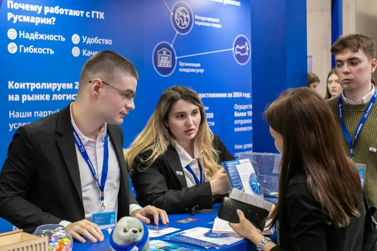 People at a business exhibition interacting with a booth