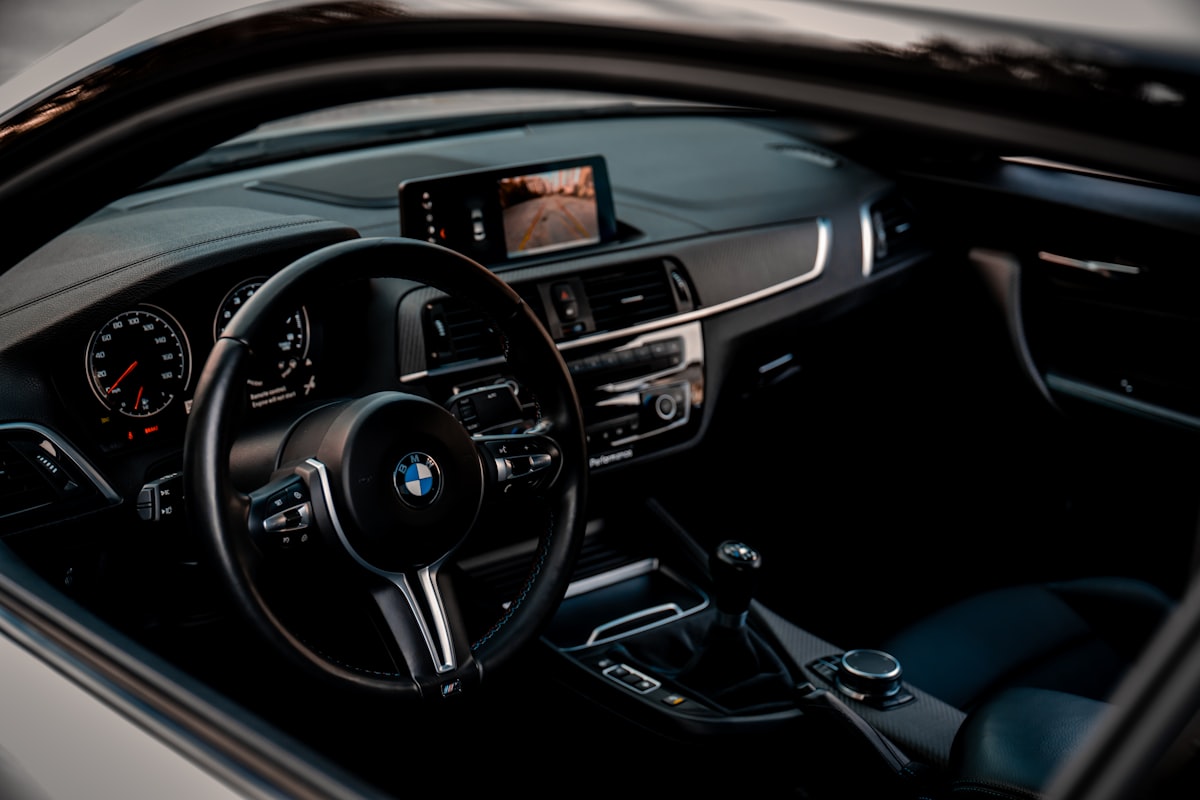 the inside of a car with a dashboard and steering wheel