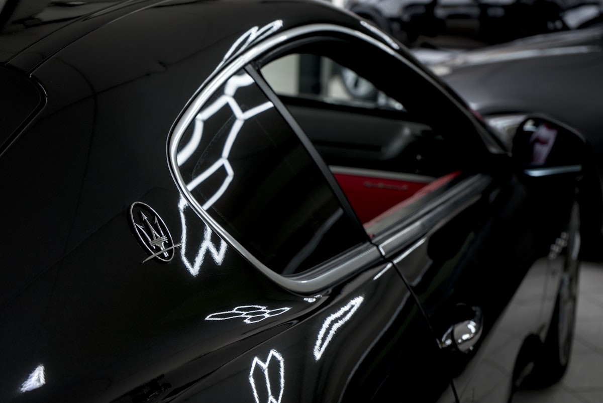 Black maserati sports car with red interior