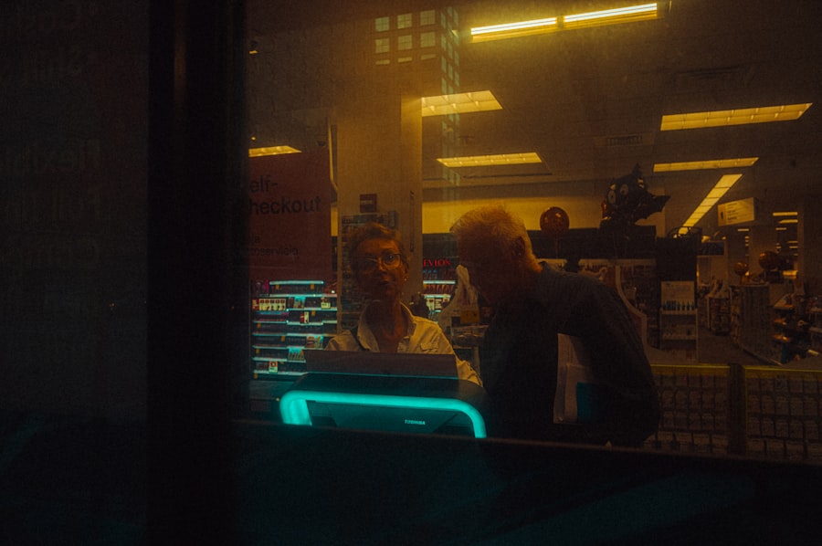 A man and a woman standing in front of a window