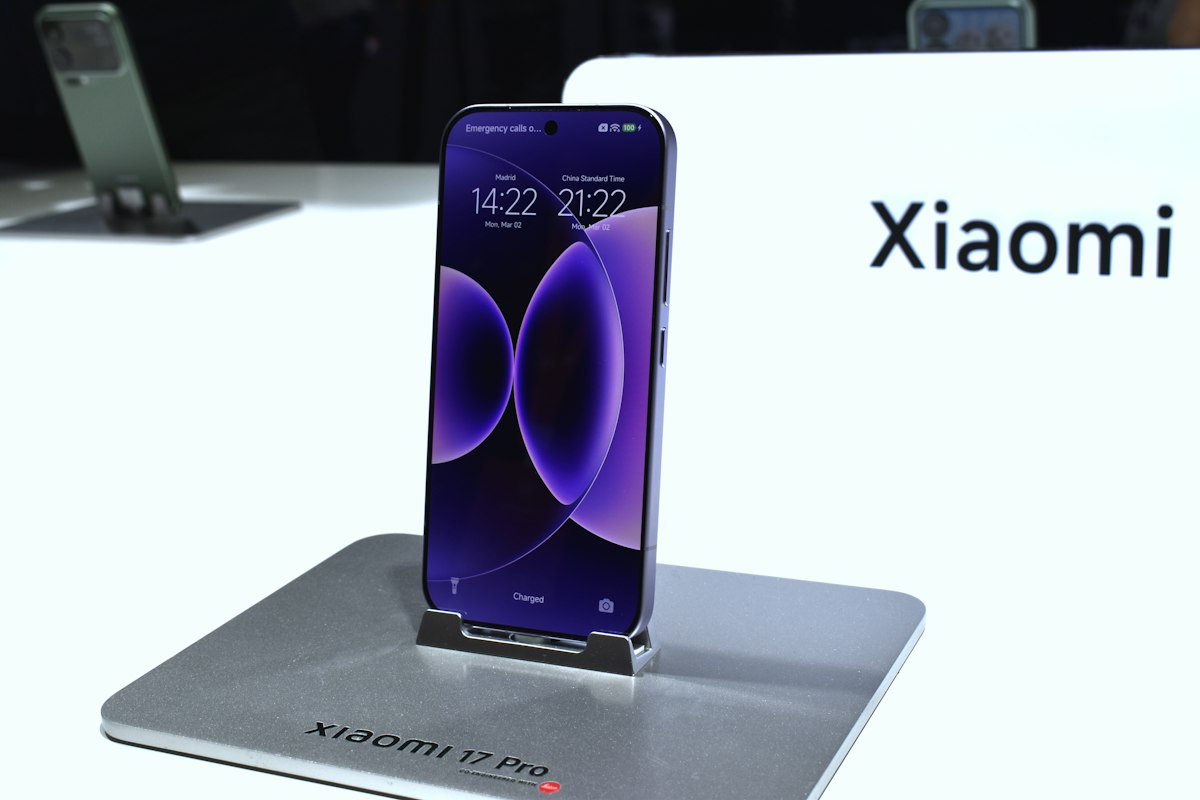 A purple xiaomi smartphone displayed on a stand