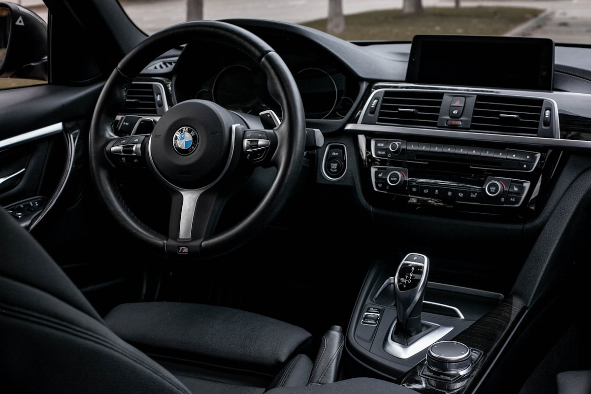 The interior of a car with a dashboard and steering wheel