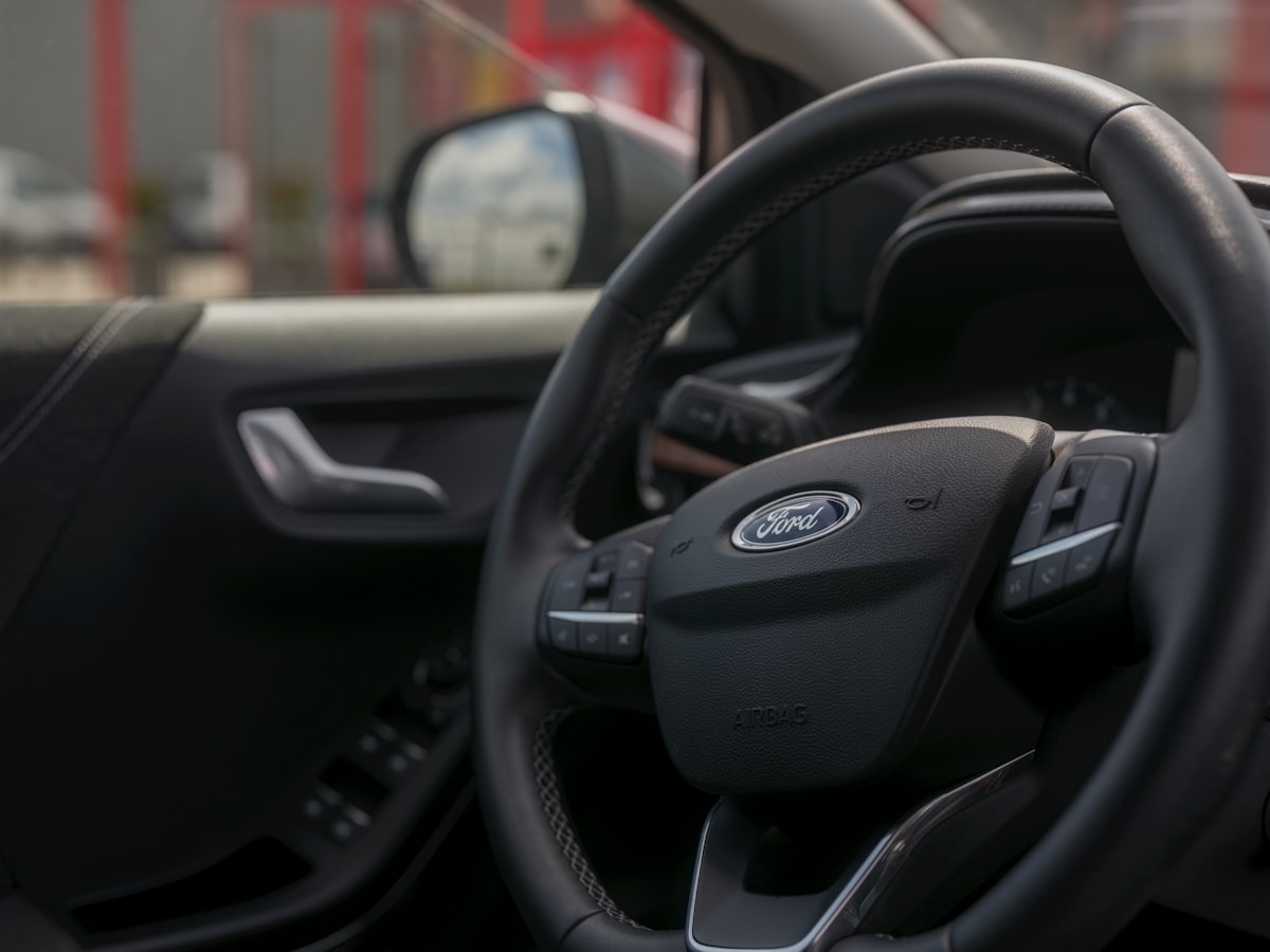 Here's a possible caption: ford puma car interior with the steering wheel.