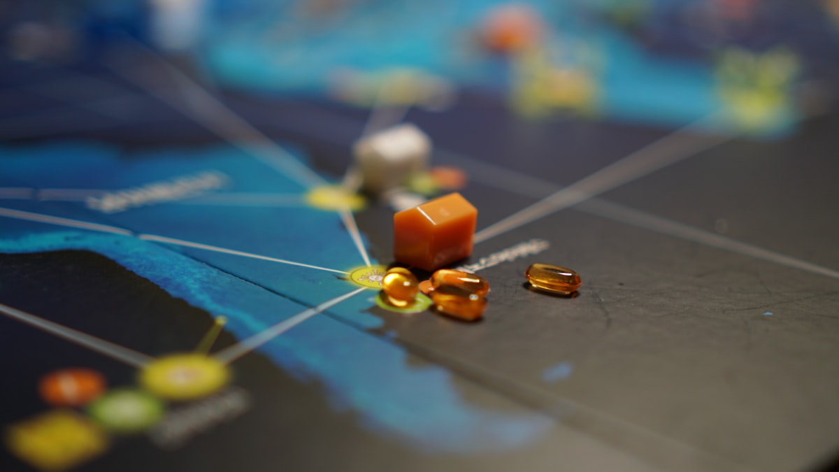 a close up of a game board with pills on it