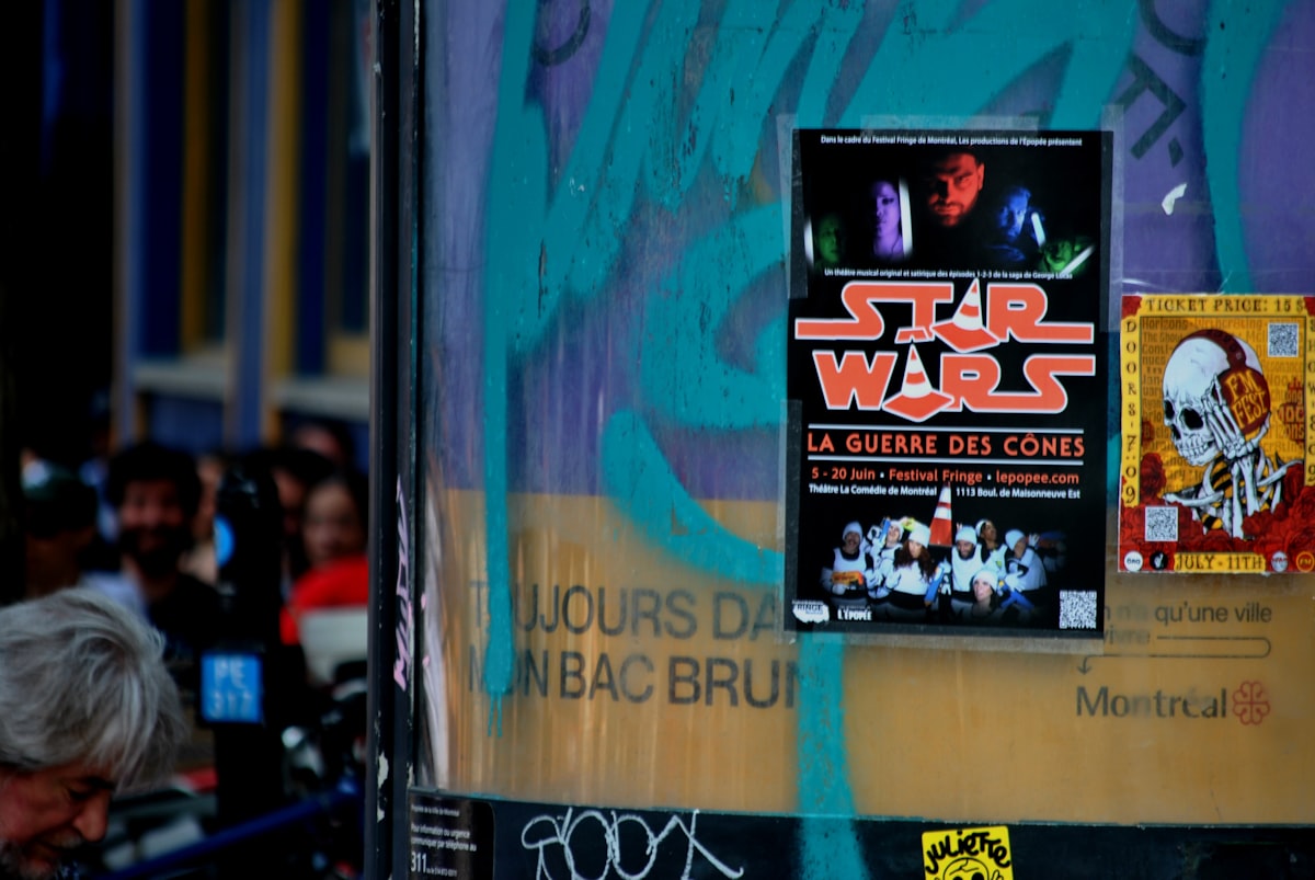 Star wars poster is displayed on a street post.