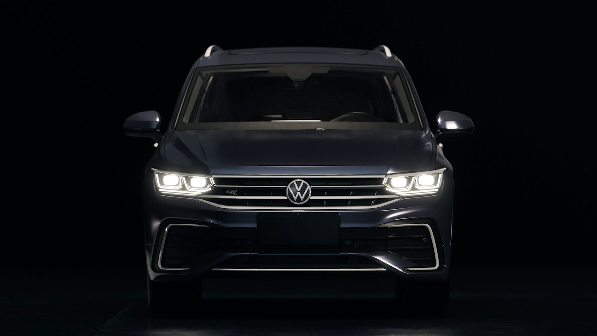 Dark blue volkswagen suv with headlights on