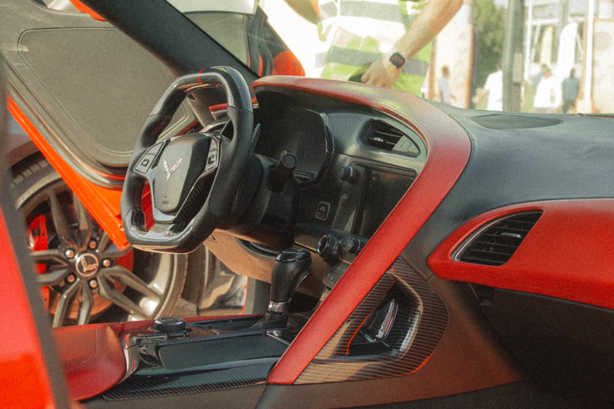 Interior of a red sports car with open door