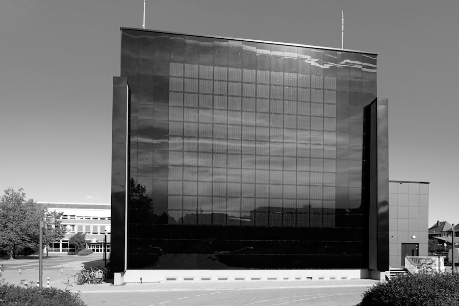 Modern glass building reflecting the sky and clouds