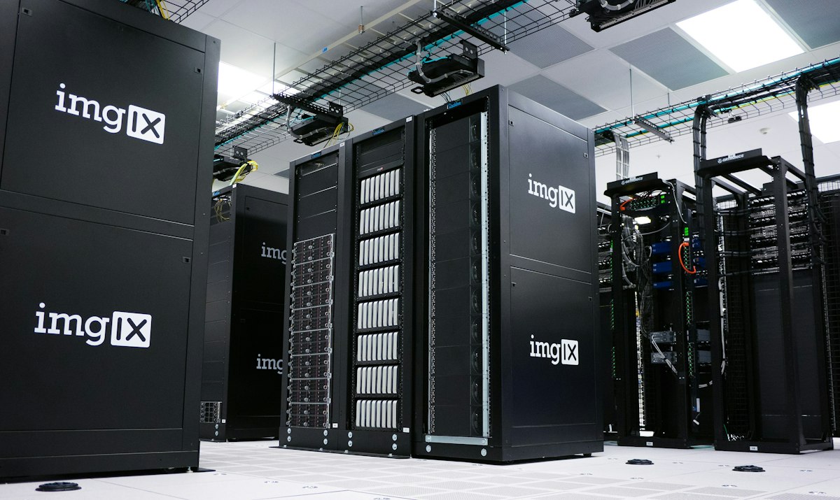 Rows of black server racks with white logos in a data center