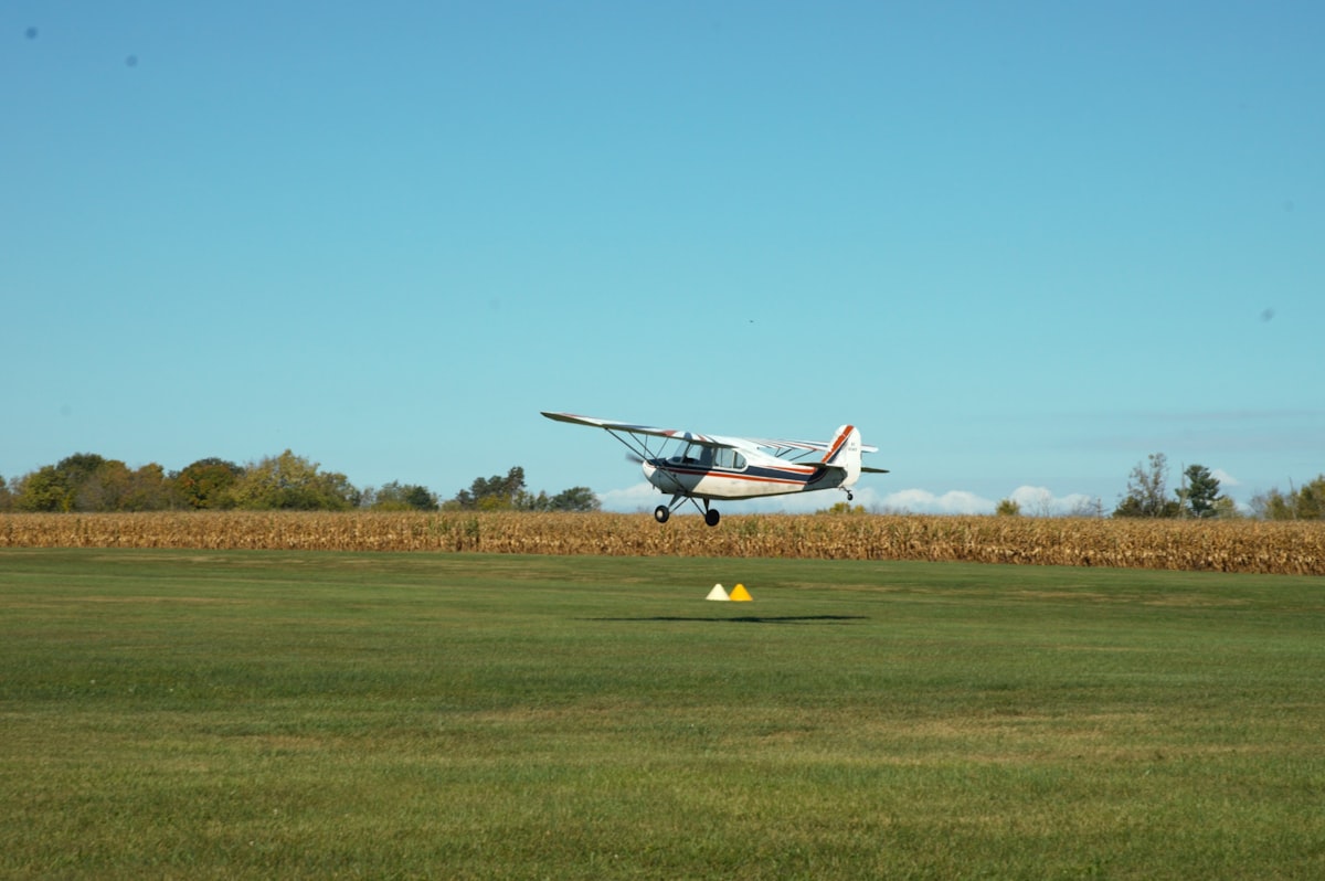a small plane taking off from an airport runway