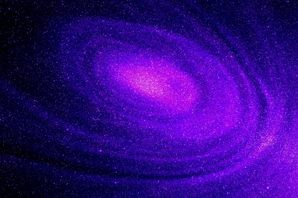A bright purple spiral galaxy glowing against a dark field of scattered stars