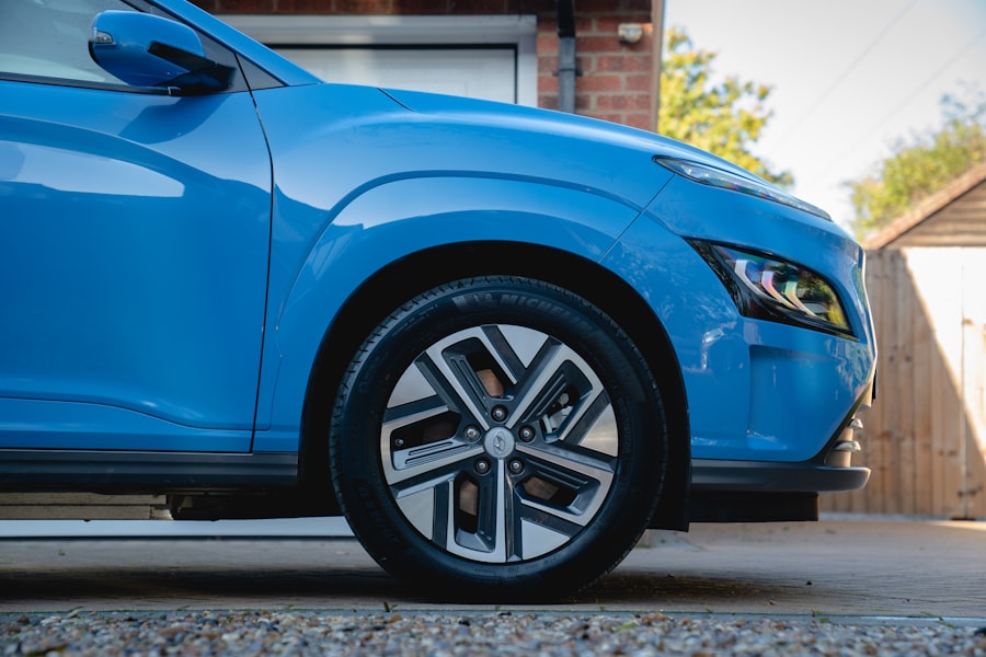 Blue car parked on a driveway in daylight