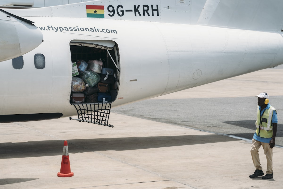 Luggage being loaded into an airplane by ground crew.