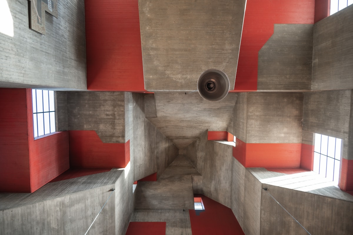 Modern concrete architecture with red accents and windows