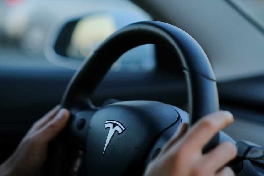 A person holding a steering wheel while driving a car