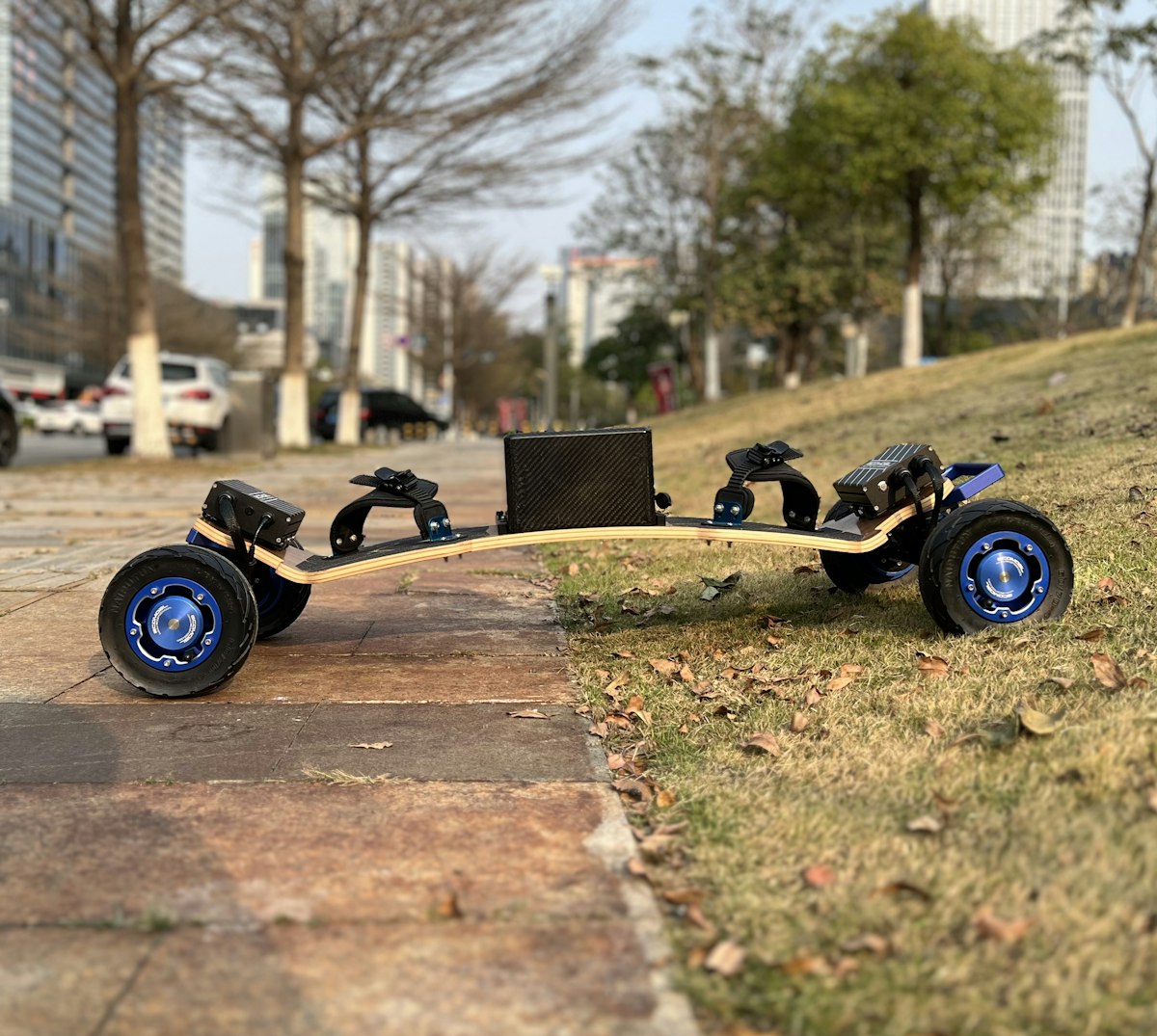 Electric skateboard with large wheels on grass