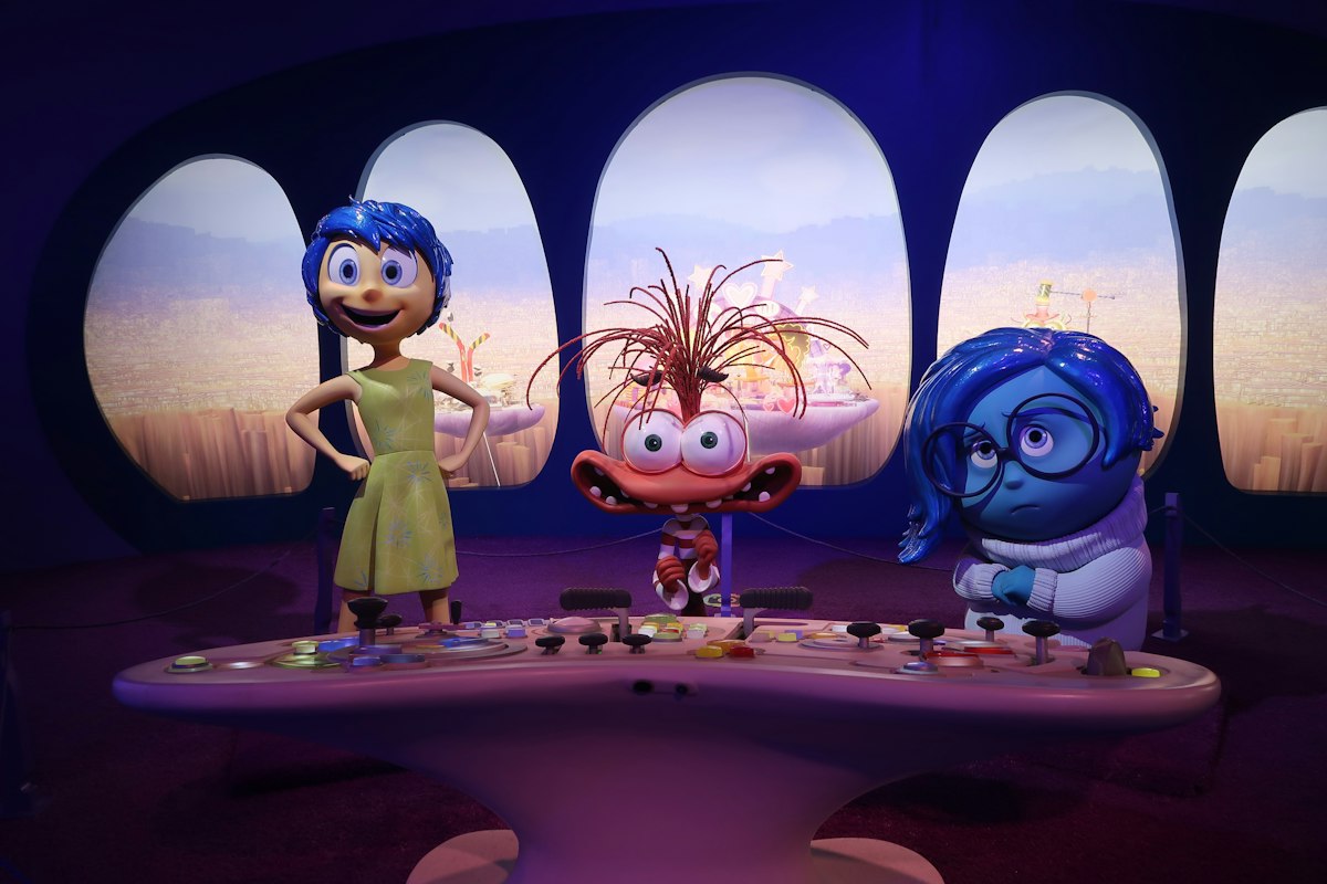 Joy, fear, and sadness characters at a control panel