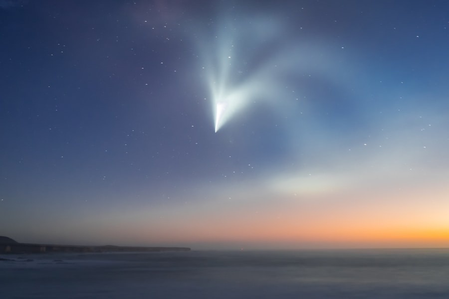 A comet is seen in the sky above the ocean