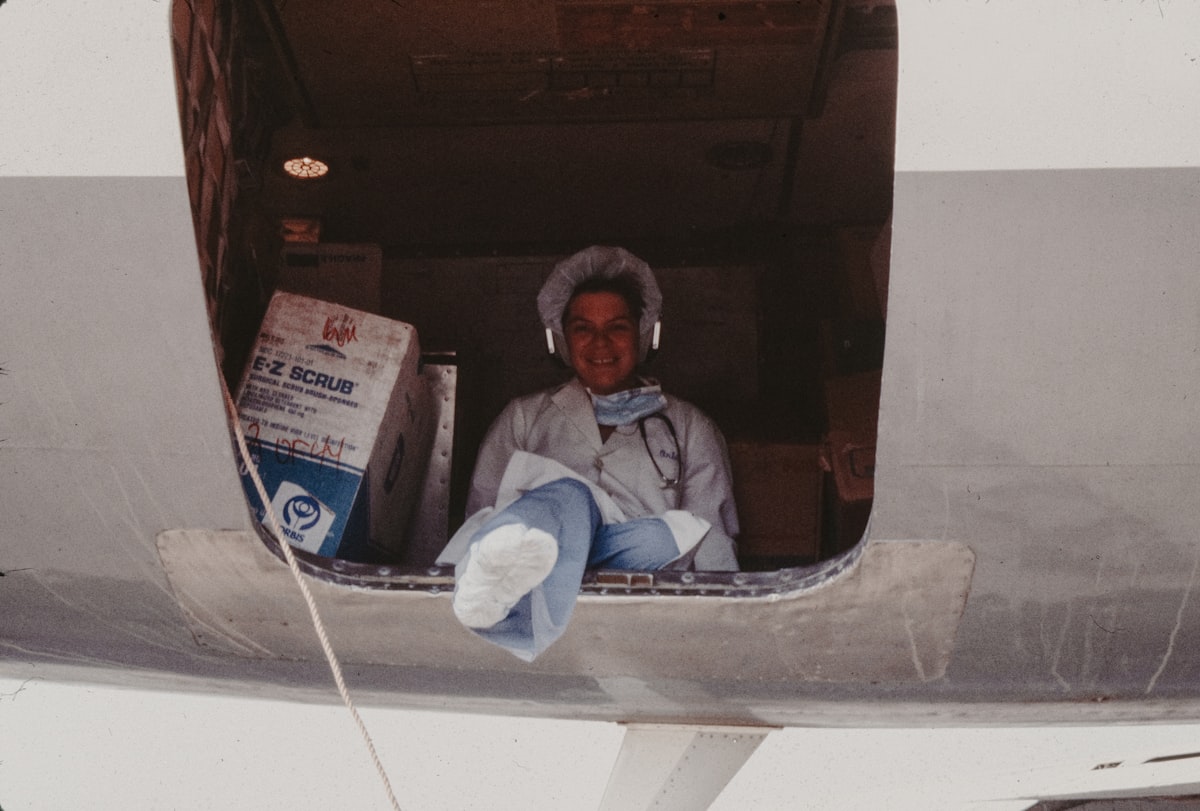 Doctor sitting in cargo plane with medical supplies