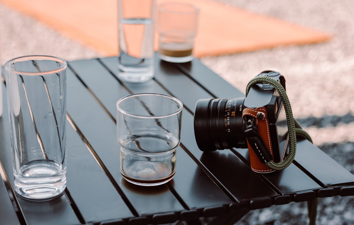 A table with glasses and a camera on it