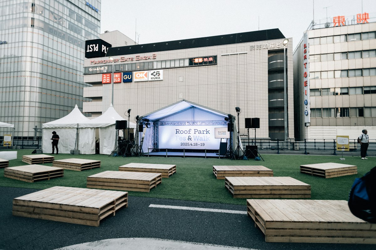 Outdoor event stage with seating and tents
