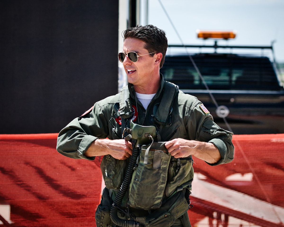 A smiling pilot puts on his flight gear