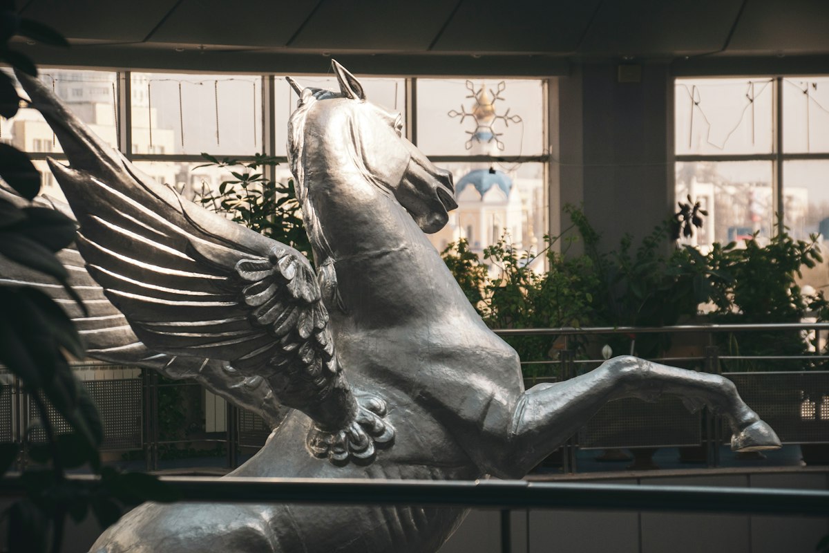 A silver pegasus statue stands tall and proud