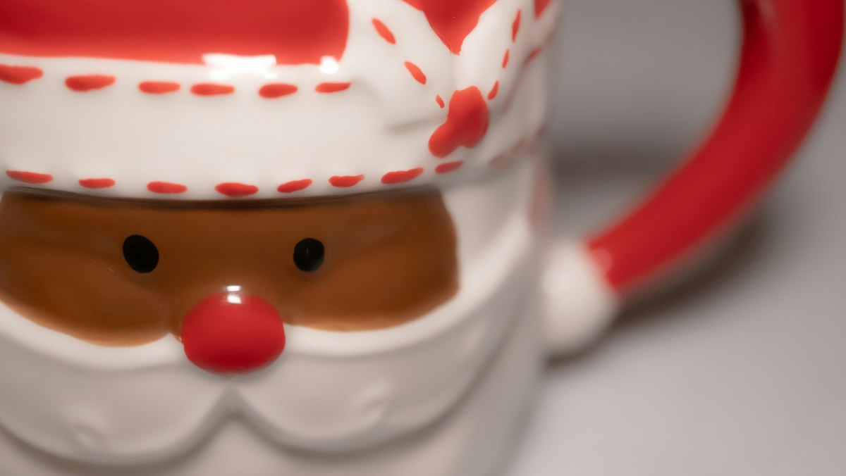 A close up of a santa claus mug