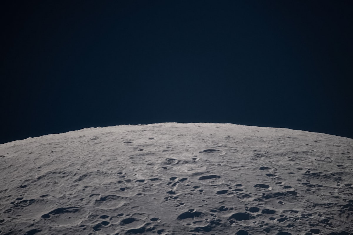 Cratered lunar surface against a dark sky