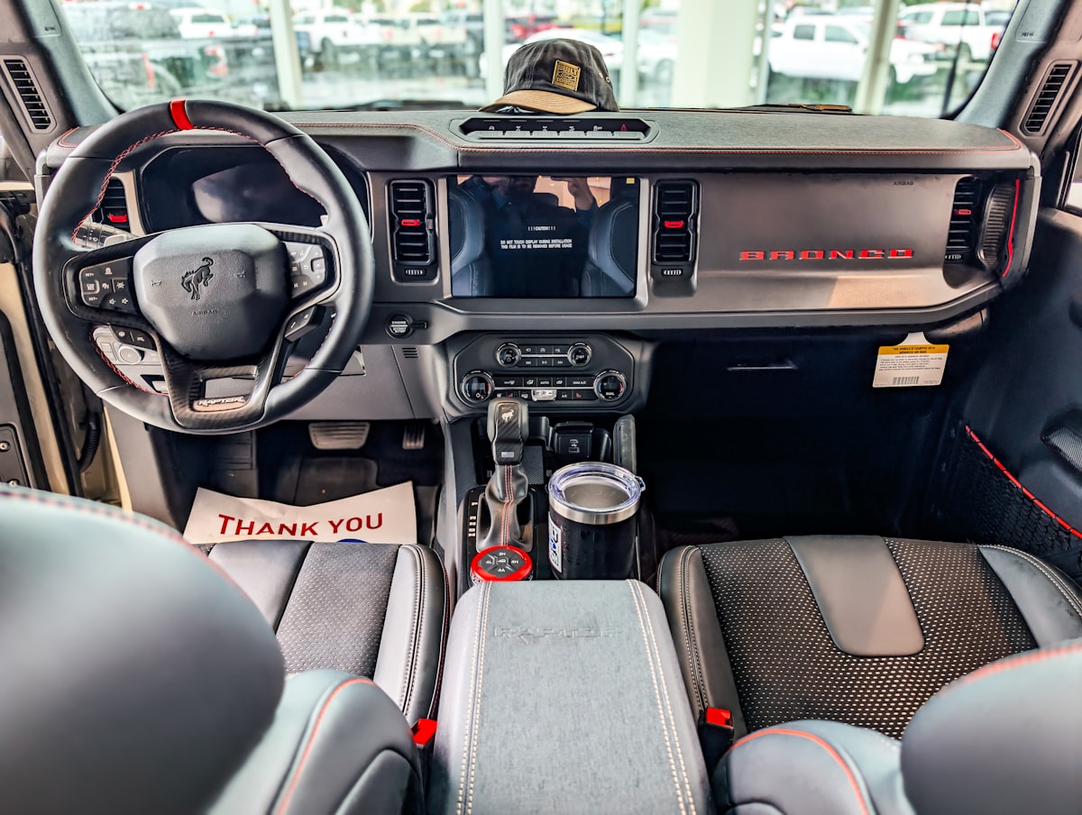 Interior of a modern suv with dashboard and dashboard details.