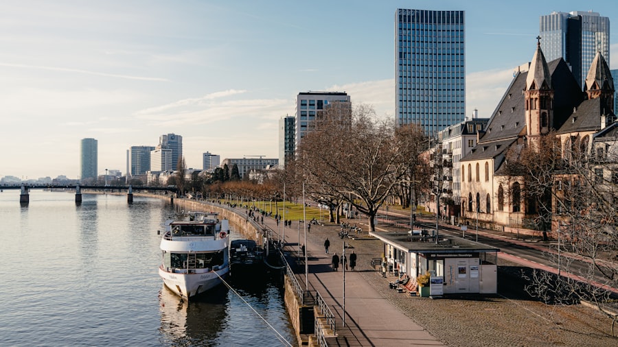 Riverfront cityscape with modern buildings and a boat.