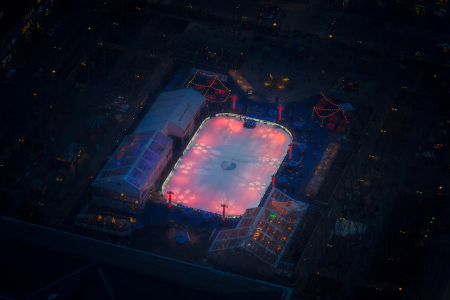 An ice rink is illuminated at night in a city.