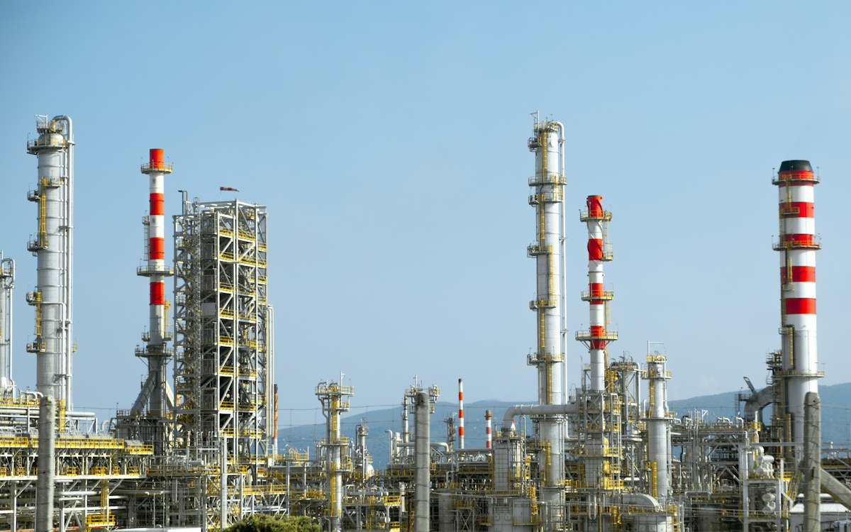 A factory with a lot of red and white pipes