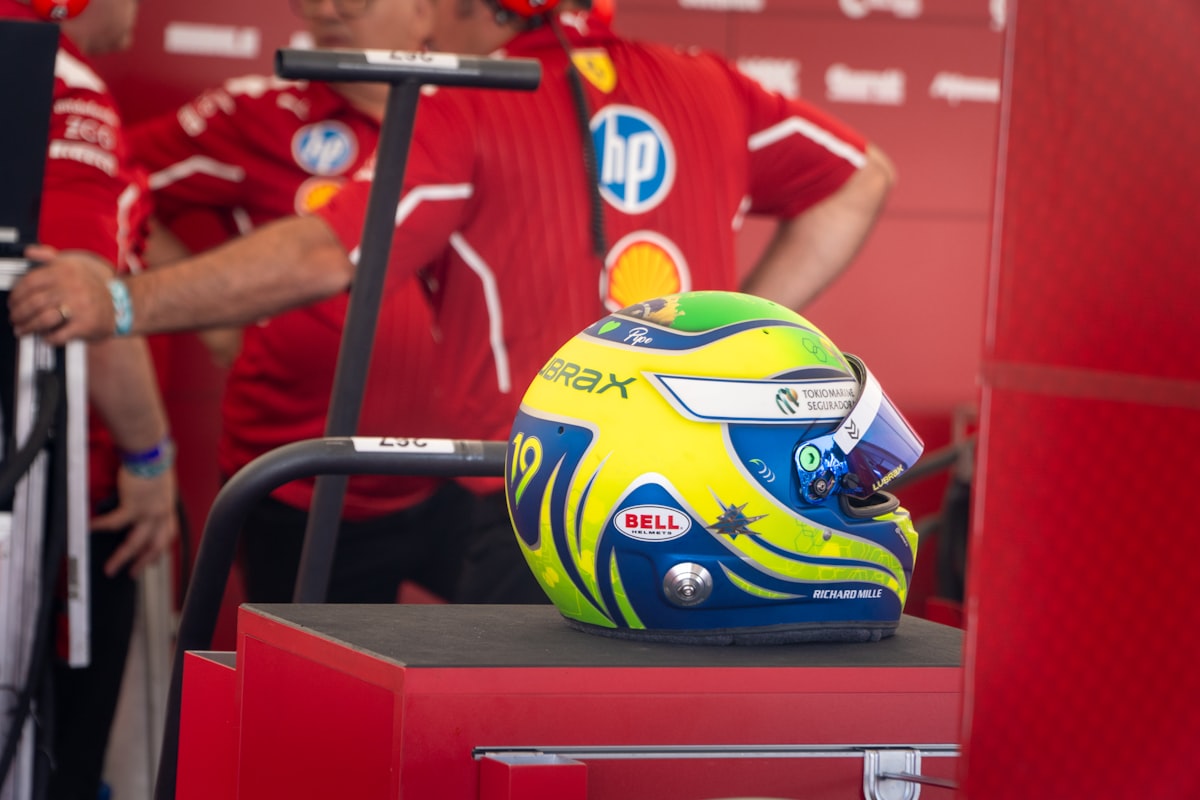 Formula 1 helmet with blue, yellow, and green design