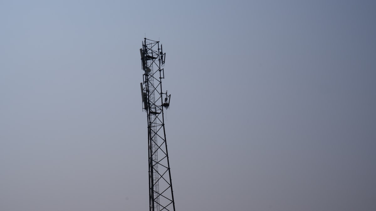 a tall tower with a cell phone on top of it