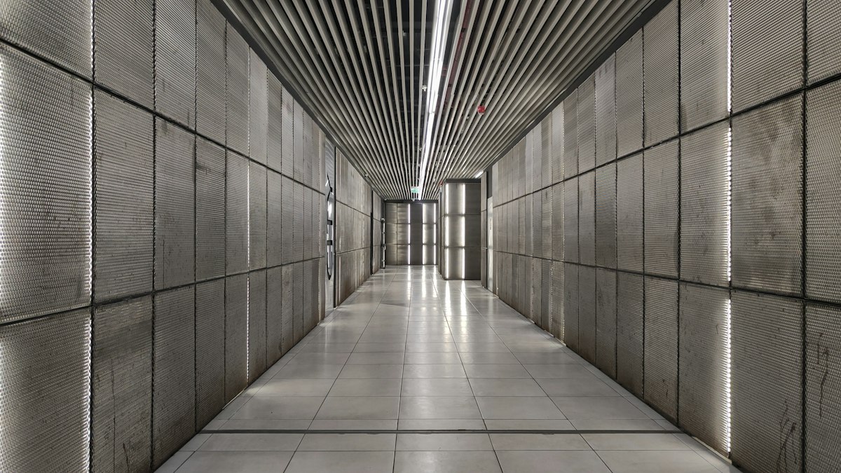 Modern concrete hallway with bright linear lights