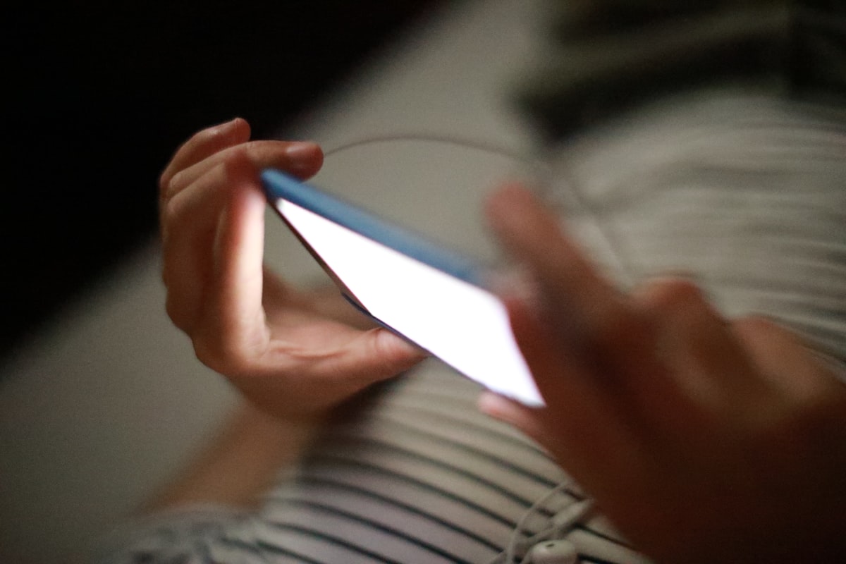 A person holding a smart phone in their hands